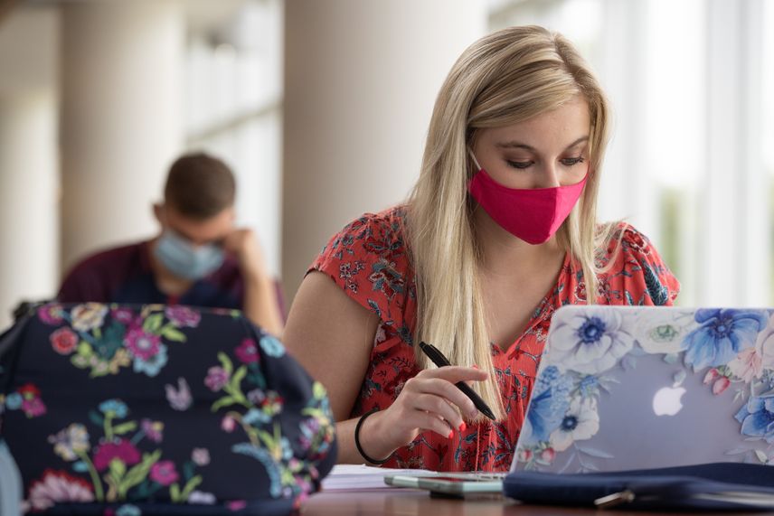 WVU, wearing face masks, students study in the Health Sciences campus library.