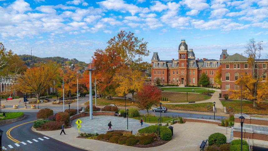 Students walk on the downtown campus of West Virginia University with Woodburn in the background on a fall day in Morgantown, Oct. 29, 2019. 