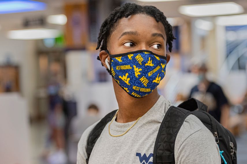 A WVU student wears a WVU face mask in the Mountainlair.