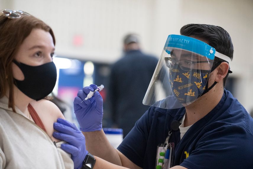 A WVU School of Nursing student administers a flu vaccine to a WVU student.