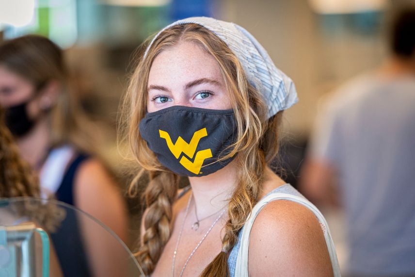 A WVU student wears a face mask while ordering her food in the Mountainlair.