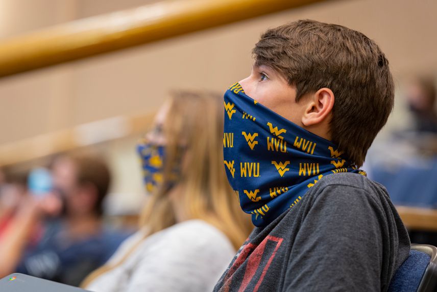 A WVU student wears a face covering known as a gaiter during a class on campus.